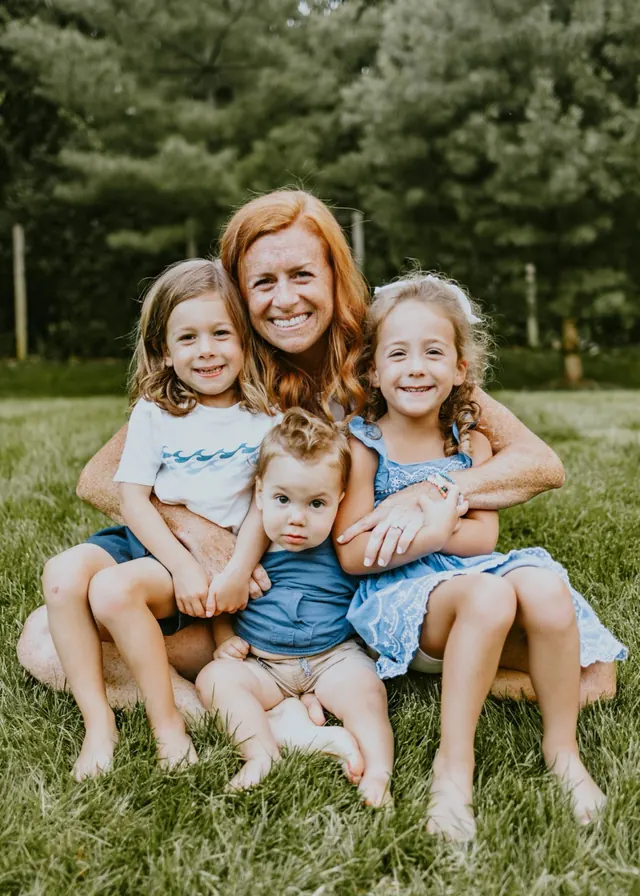 Kate with her three children on the grass