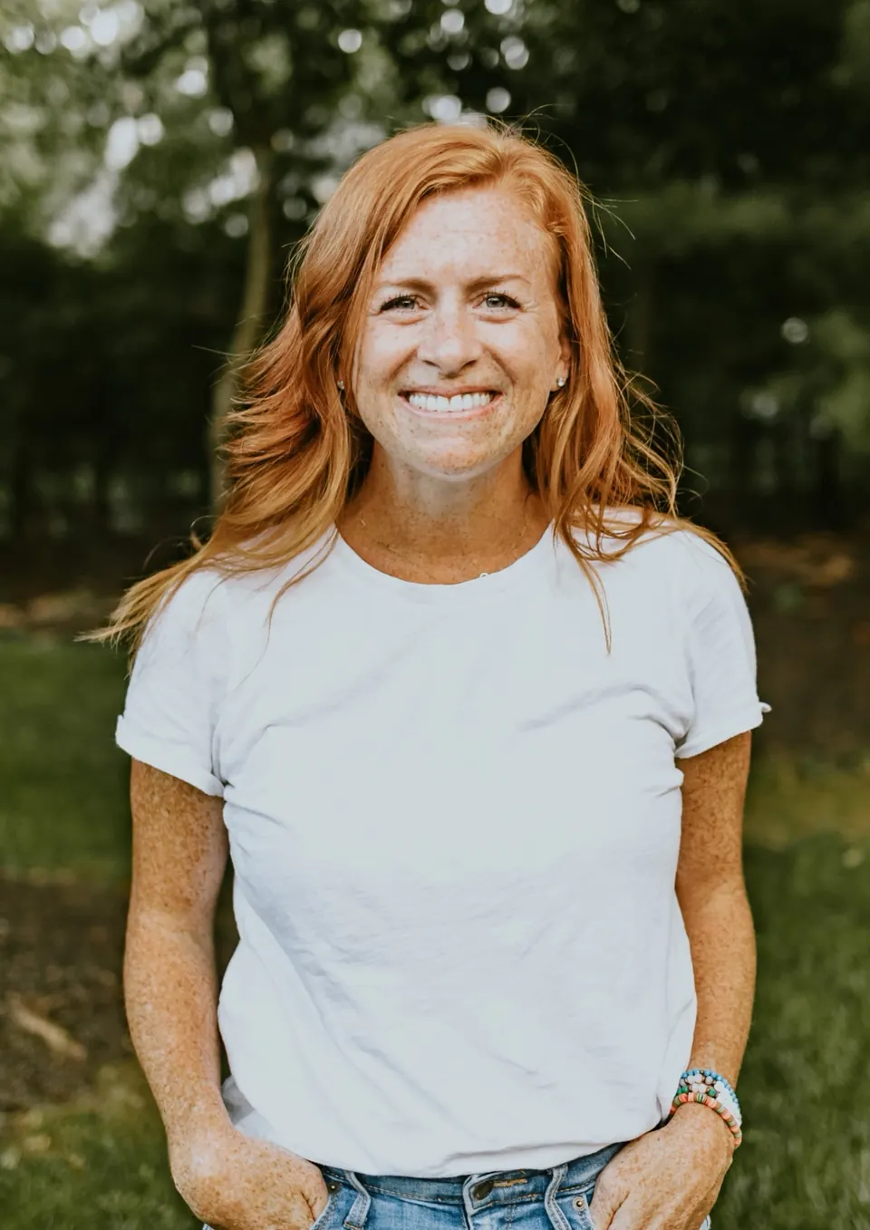 Kate Faraci standing outdoors in a white t-shirt